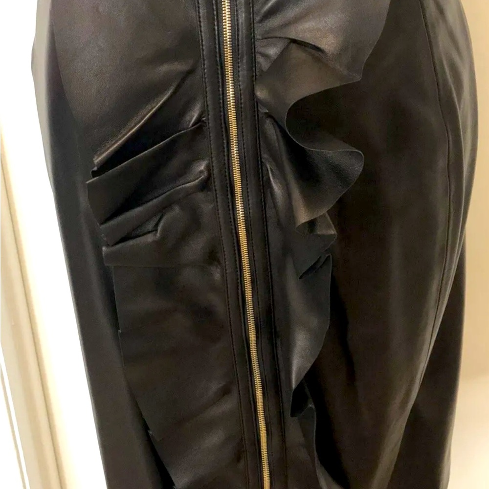 New with tags, Carolina Herrera Leather skirt. Gold Zipper front with ruffle.